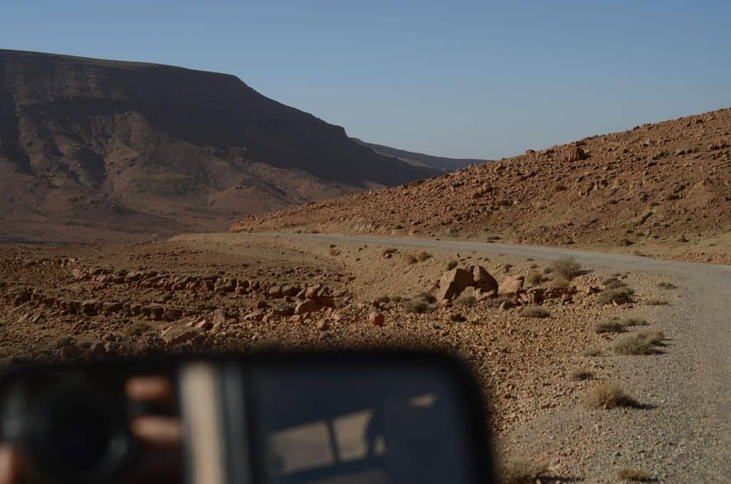 F-150 Towing Capacity: What Size Travel Trailer Can an F-150 Pull? 3 Gravel road winding through a rocky desert valley, seen from the driver’s seat