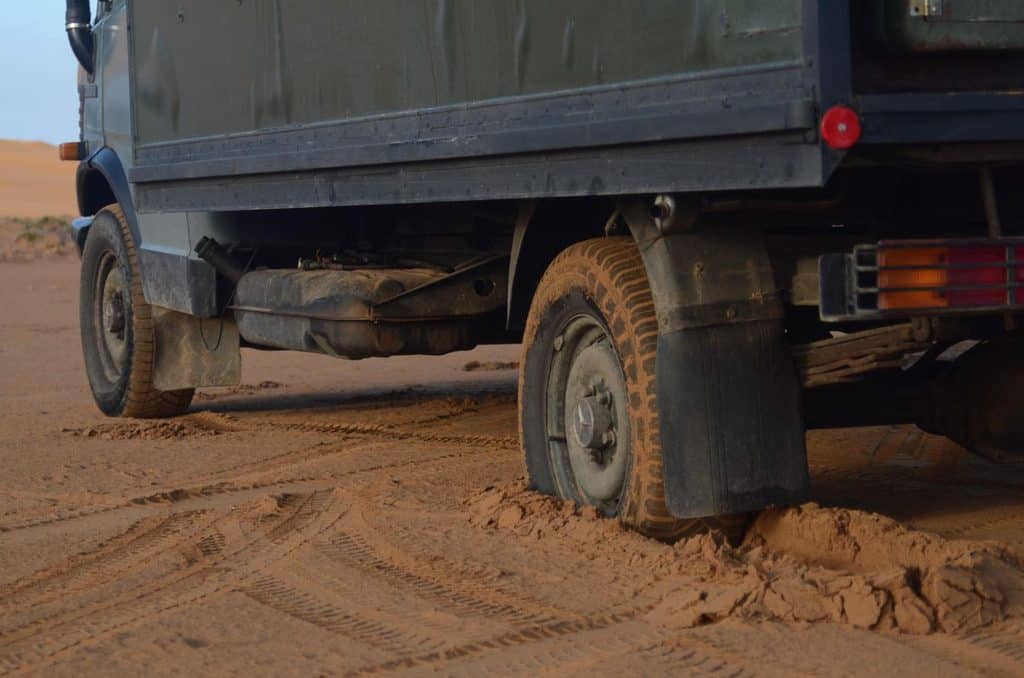 F-150 Towing Capacity: What Size Travel Trailer Can an F-150 Pull? 2 Camper truck with its wheels stuck in deep desert sand