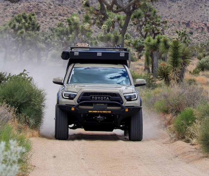 Top 7 Amazing Truck Campers For The Toyota Tacoma 3 Vagabond Drifter lightweight pop-up truck camper on a Toyota Tacoma in the desert